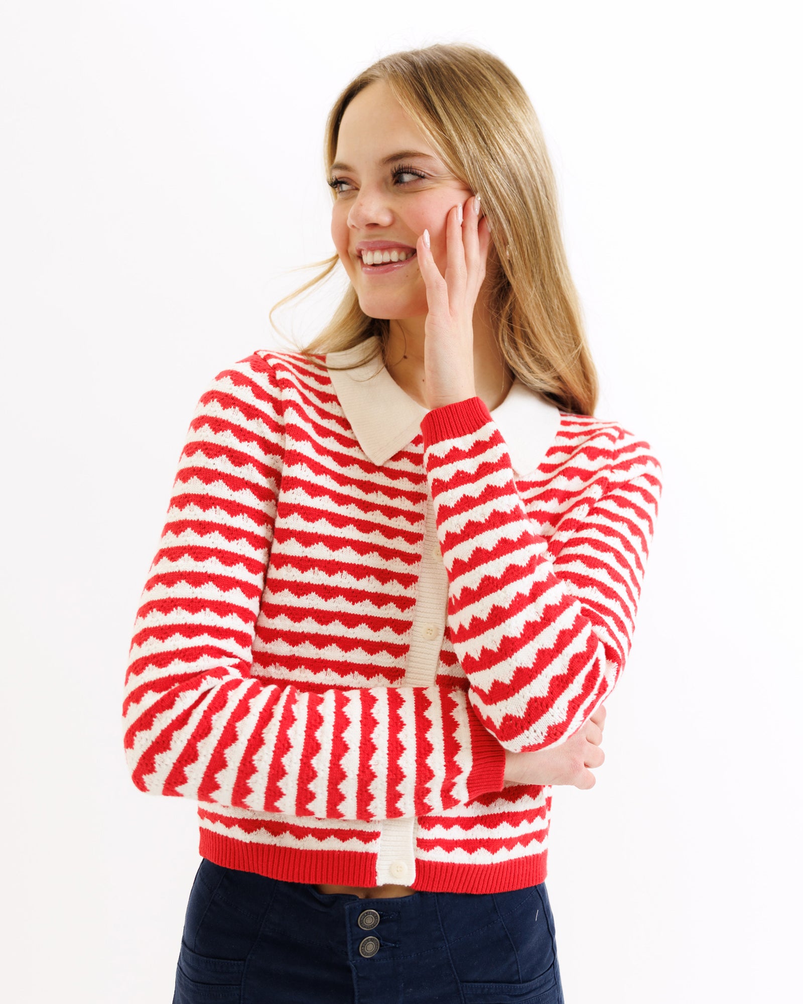 Woman wearing a red and white striped sweater on a white background