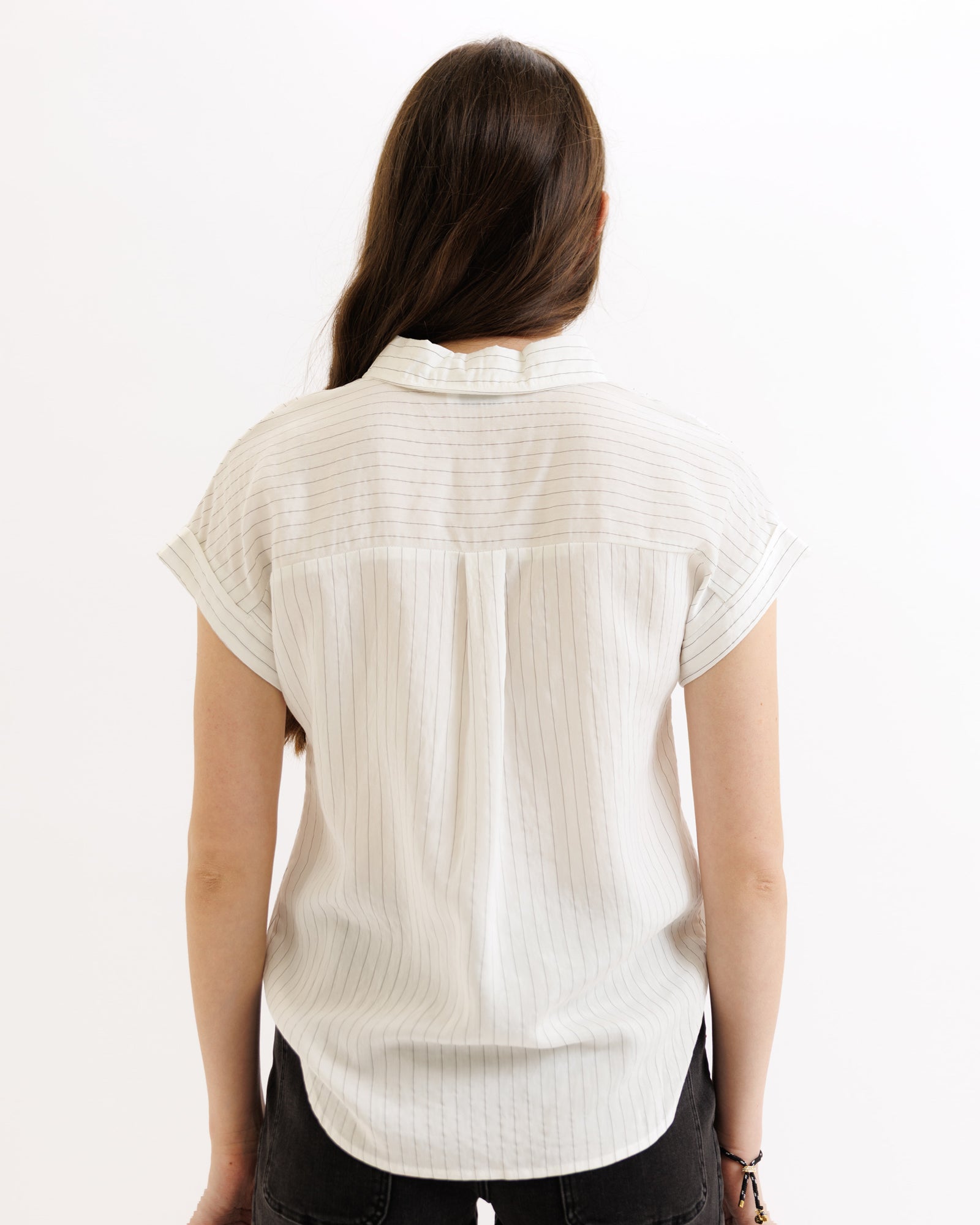 Person wearing a white short-sleeve shirt on a white background