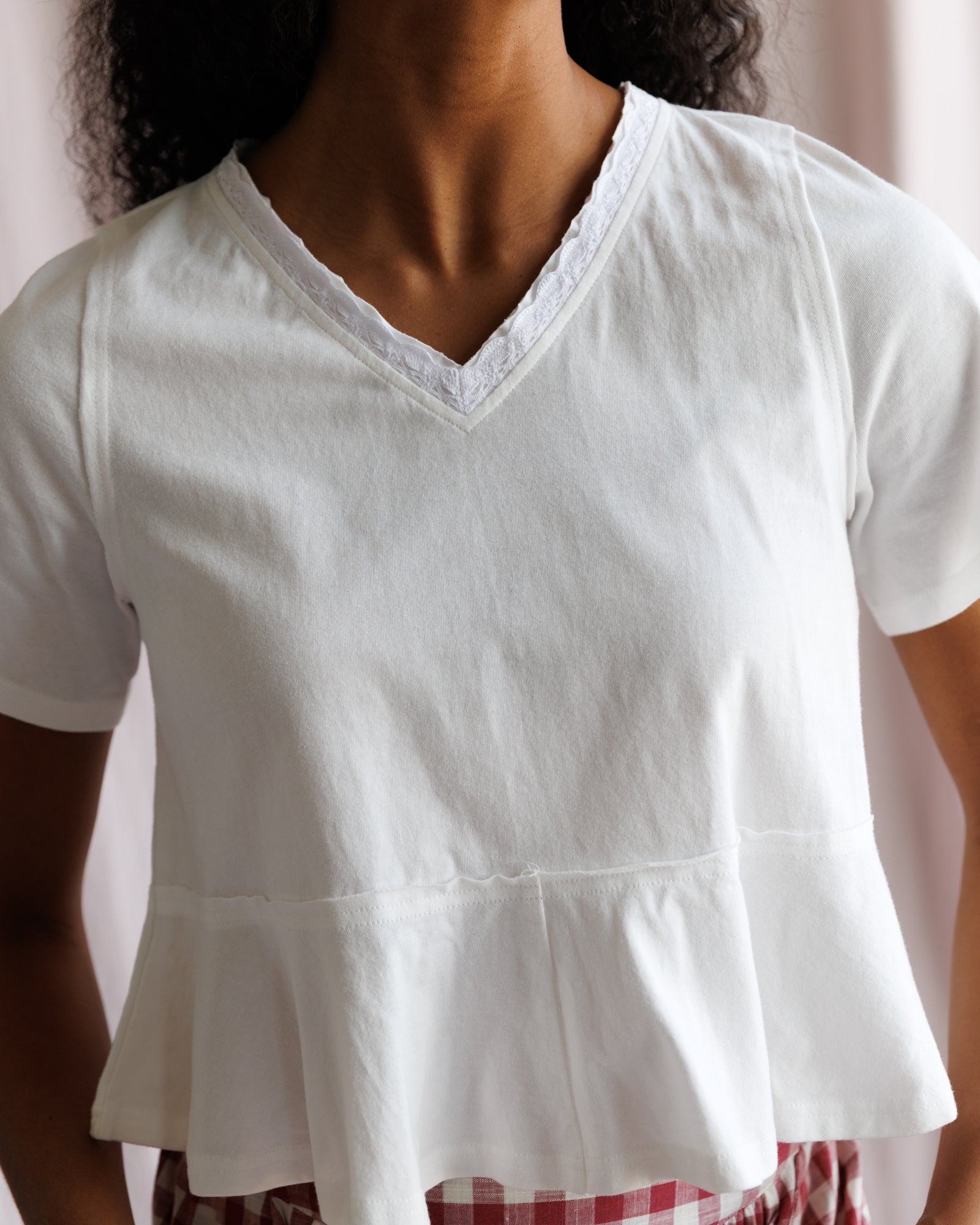 White blouse worn by a person with a blurred background