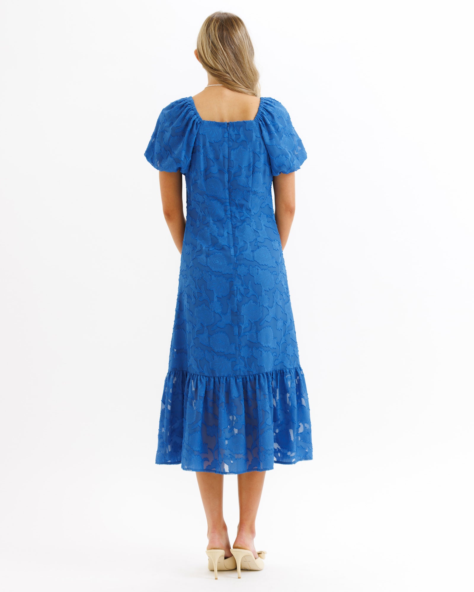 Woman wearing a blue dress on a white background
