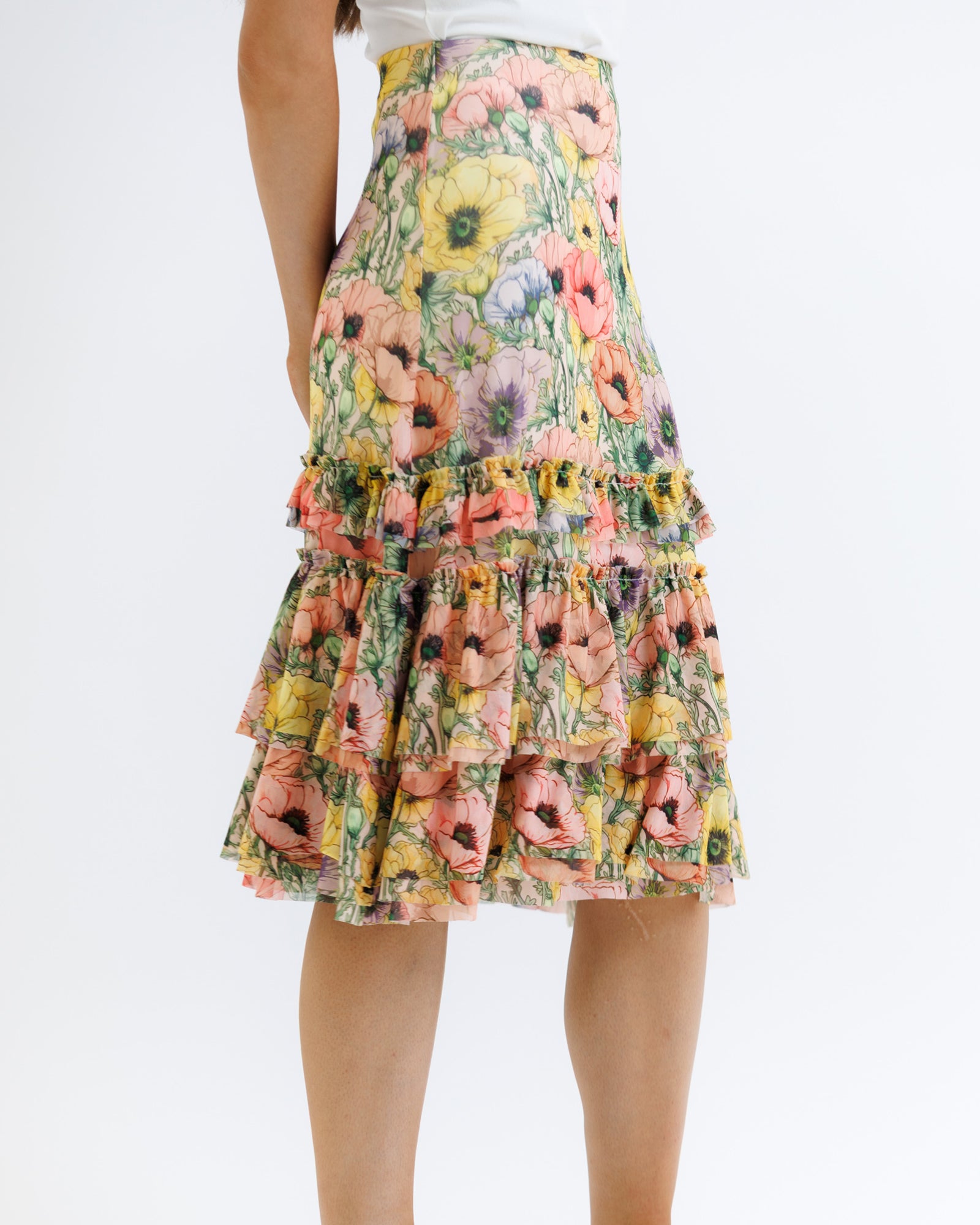 Floral tiered skirt worn by a person on a white background