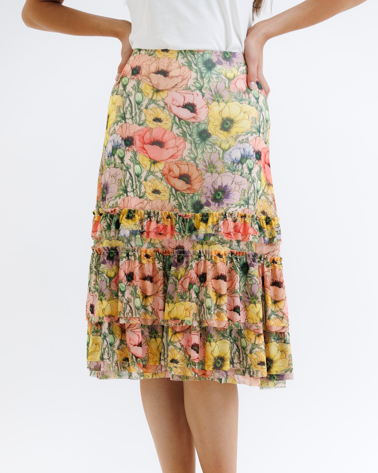 Floral skirt worn by a person on a white background