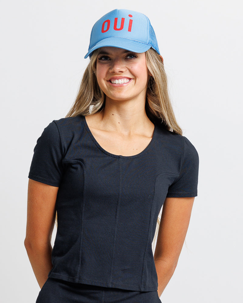 Model wearing a black short sleeve scoop neck tee