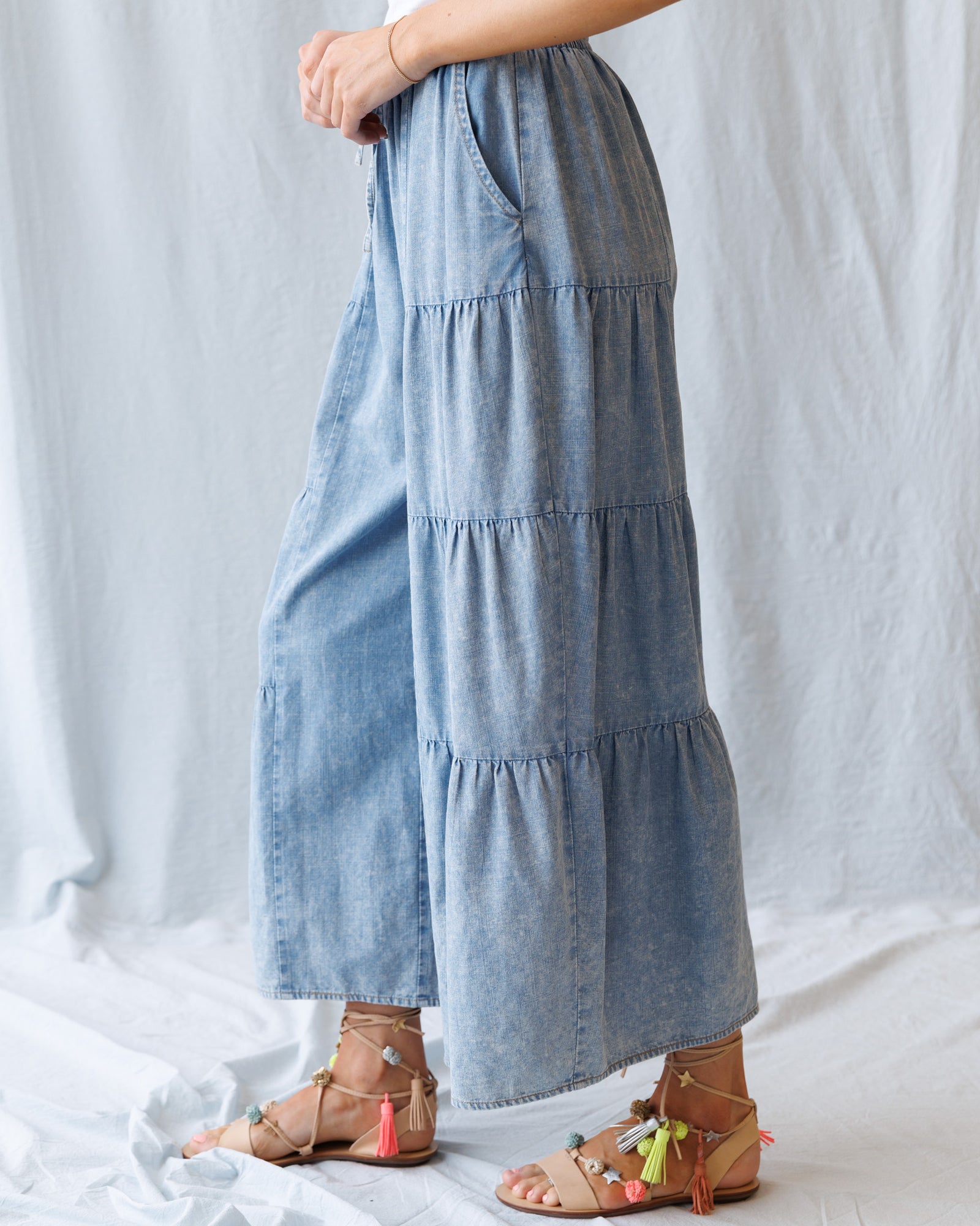 Light blue tiered skirt worn by a person on a white background
