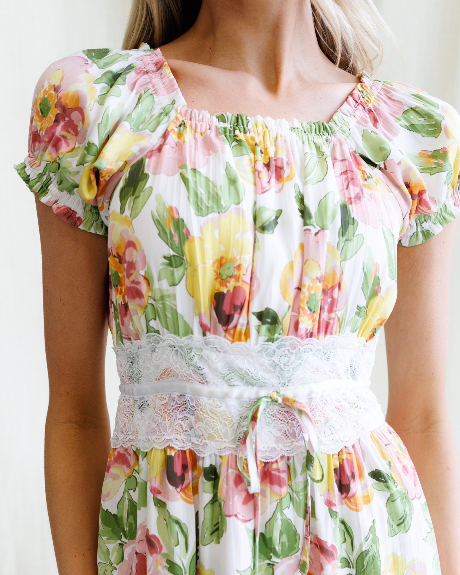 Floral dress with lace details on a plain background