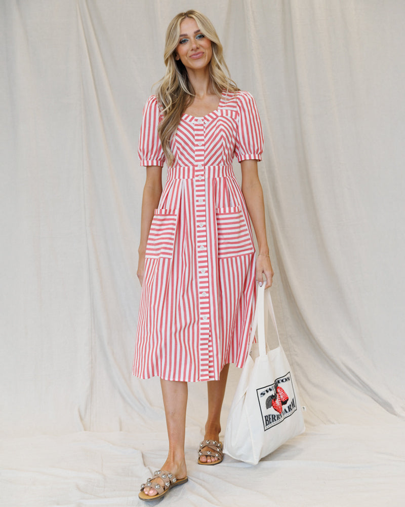 Image of a woman wearing a red and white striped midi length dress on a canvas background