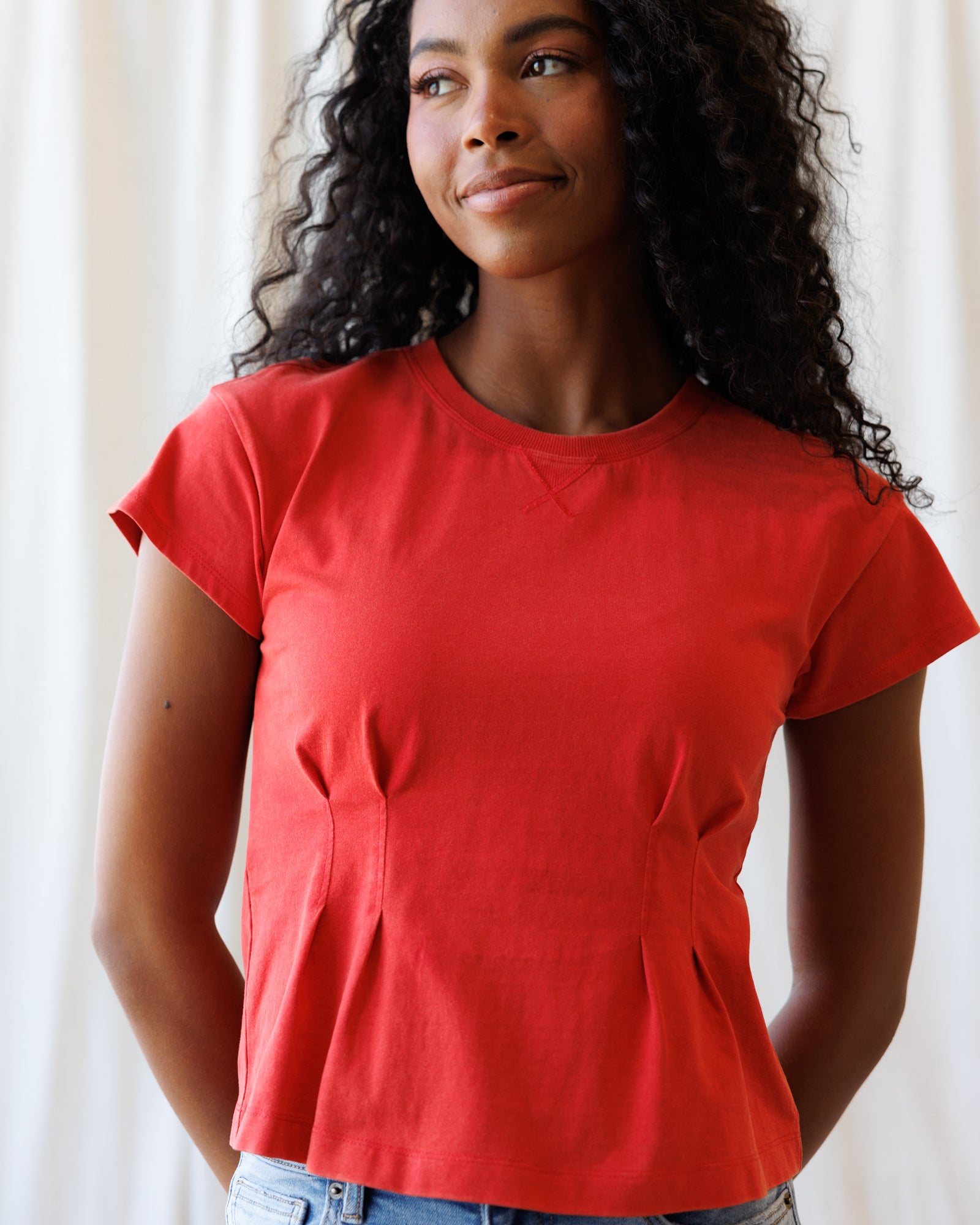 Woman wearing a red t-shirt against a white background