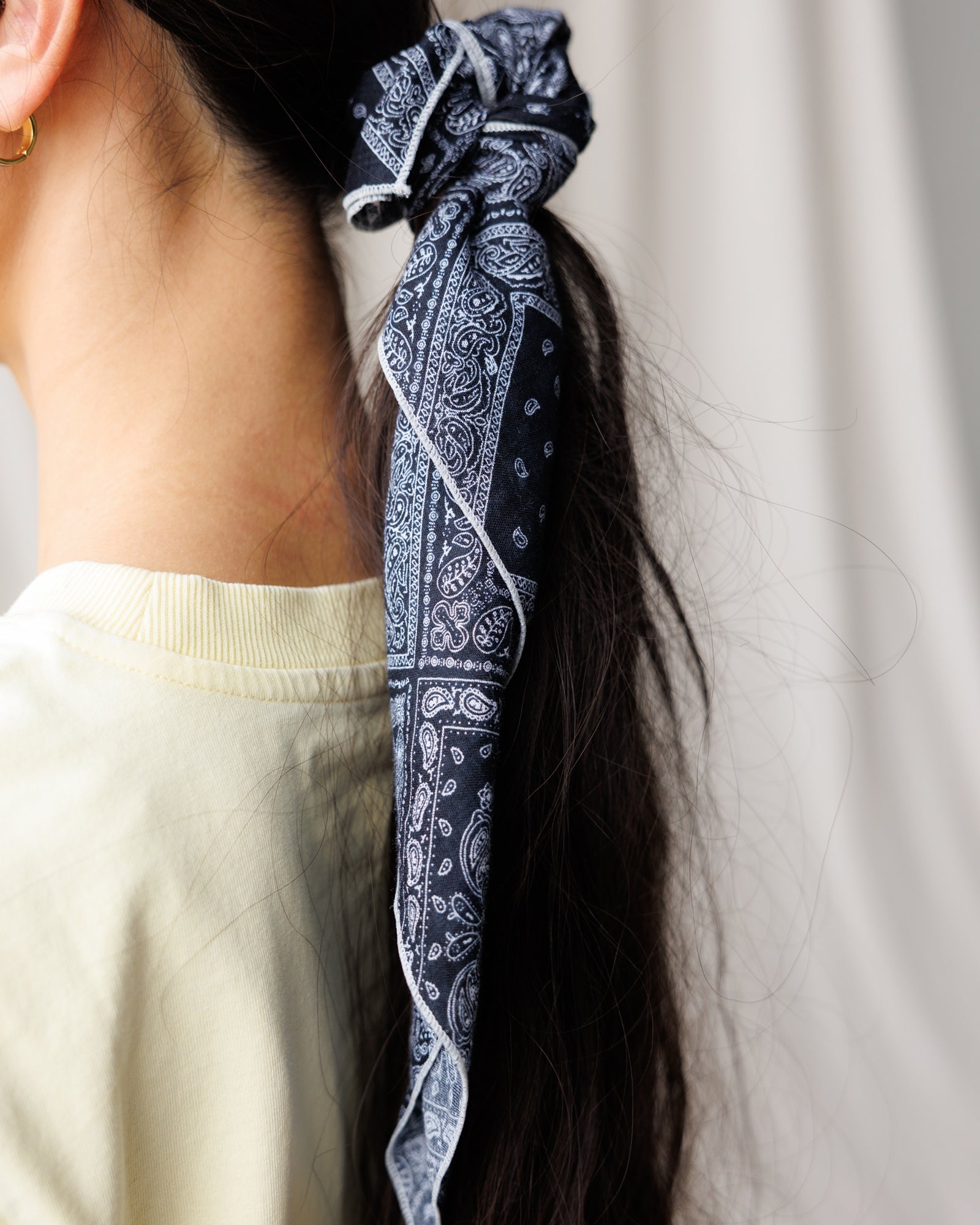 Image of a woman wearing a scarf in their hair