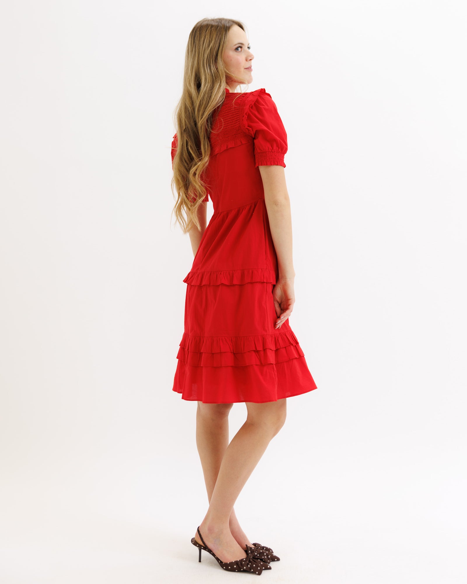 Woman wearing a red dress on a white background