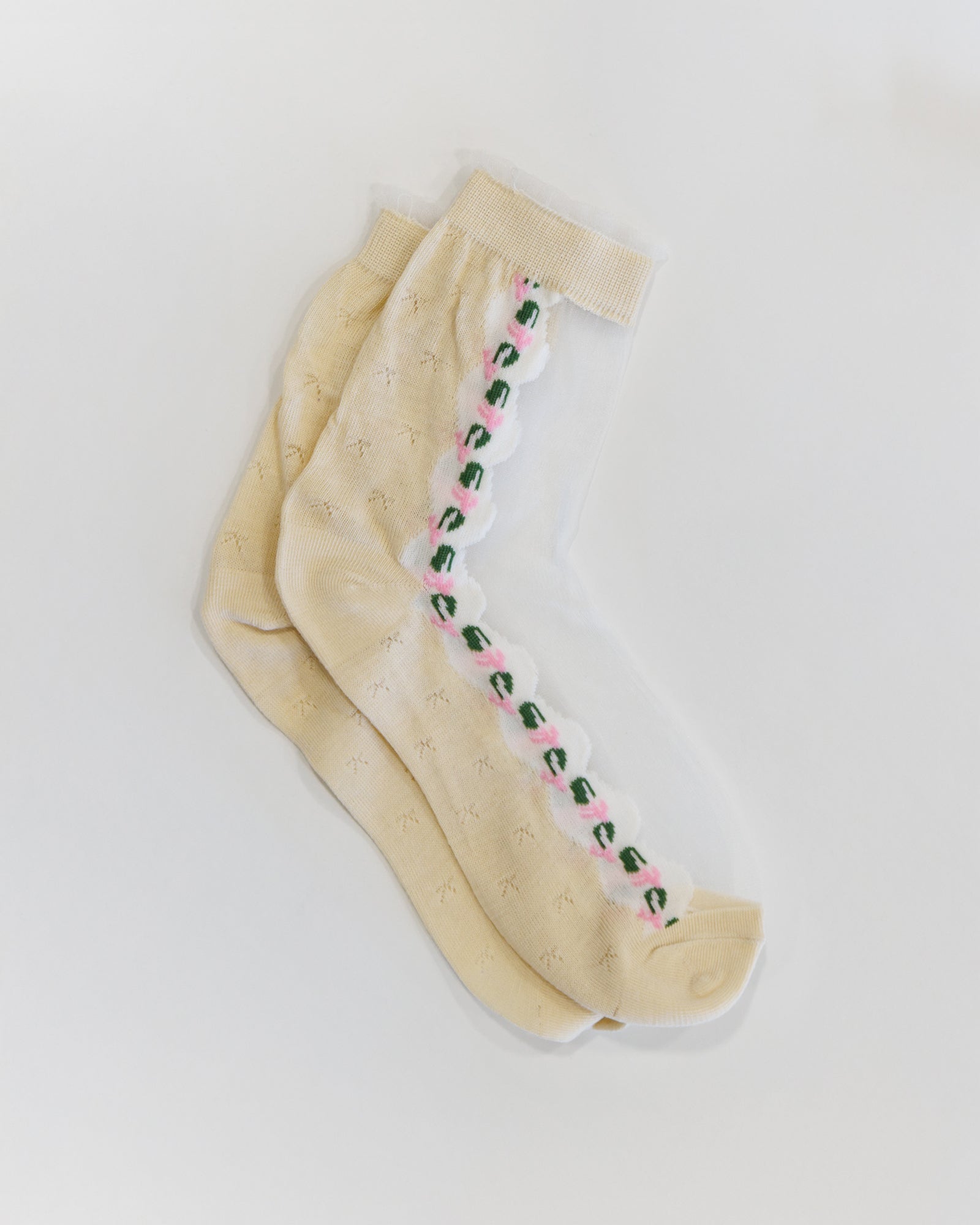 Beige tights with floral design on a white background