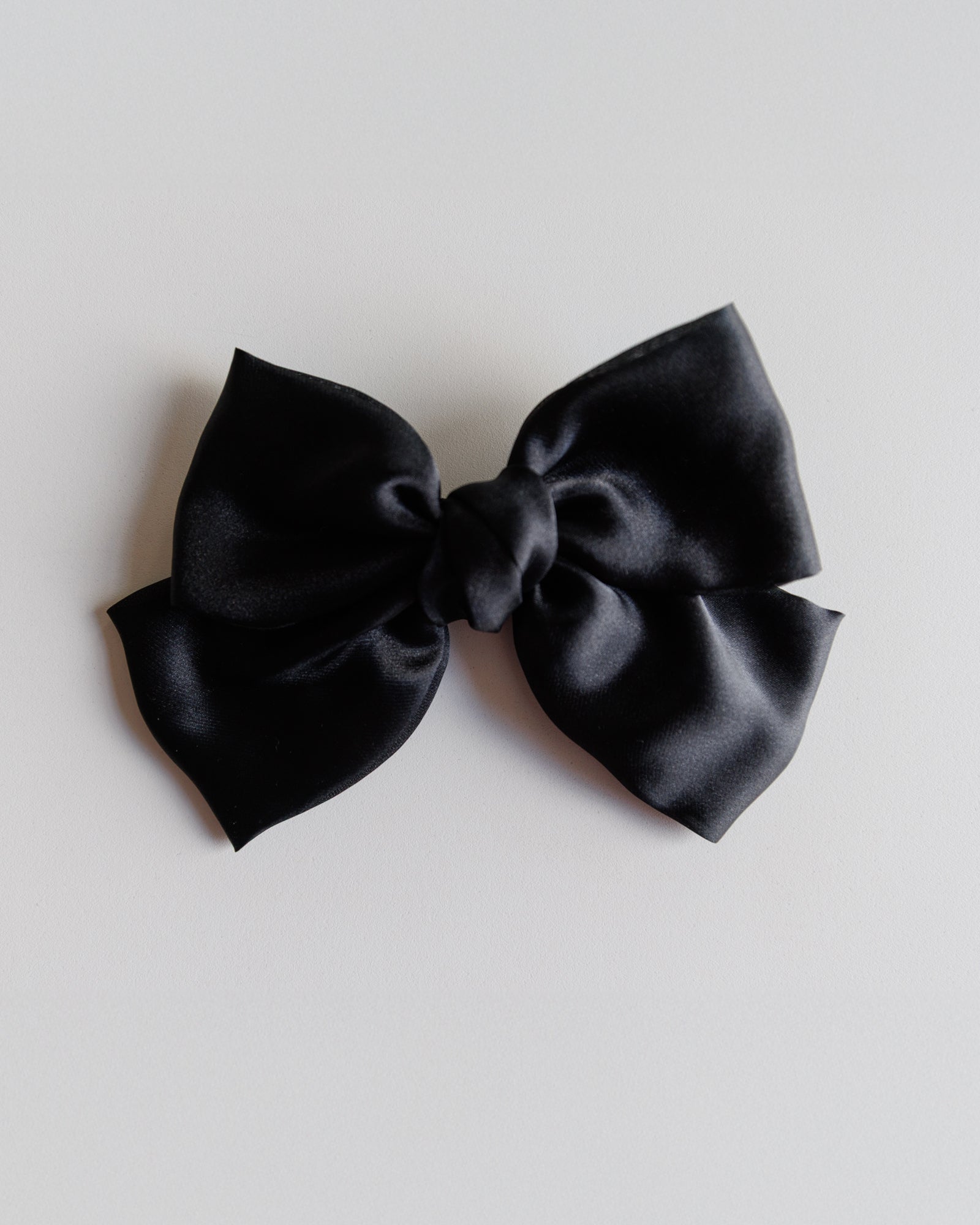 Black bow on a light gray background