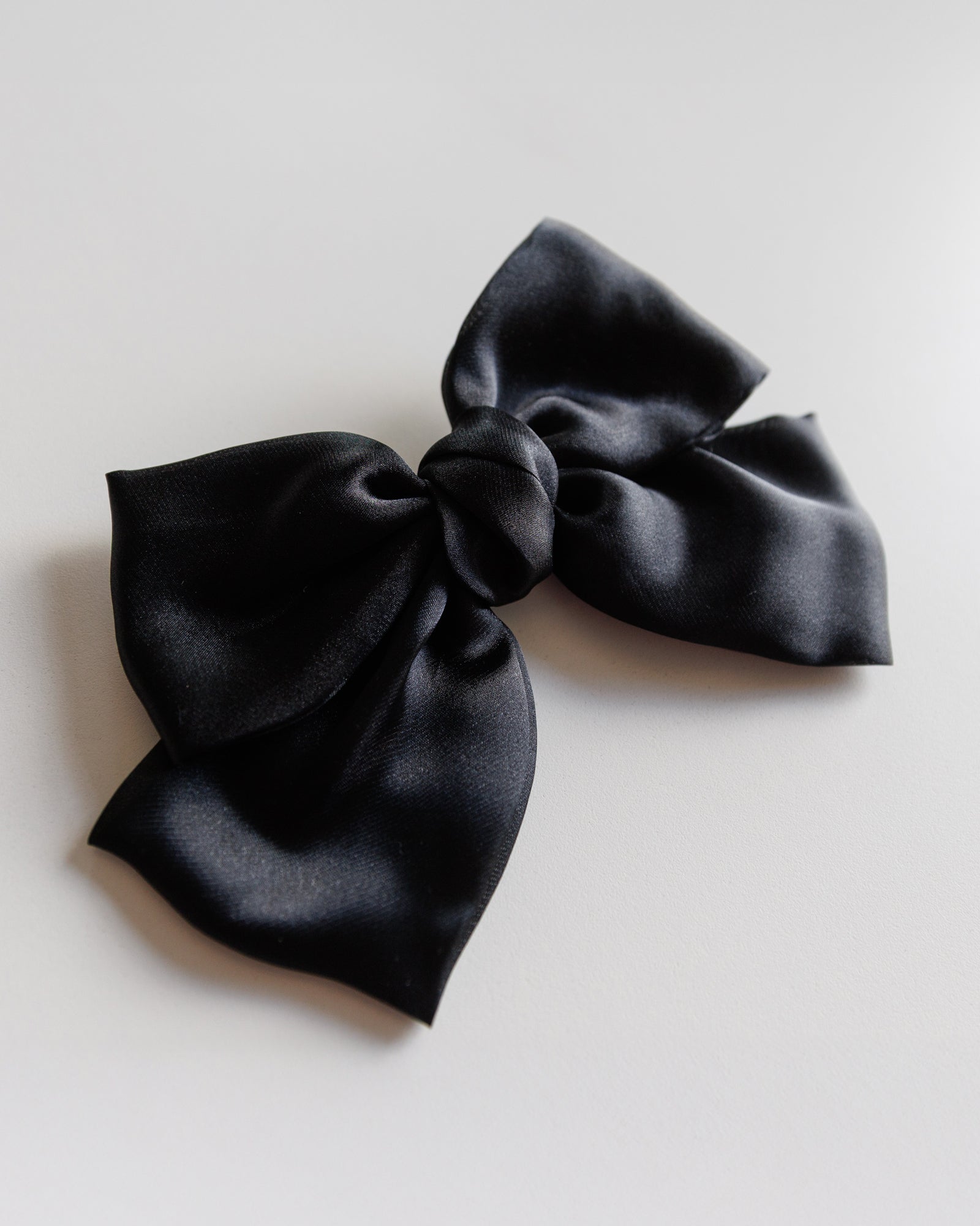 Black bow on a light gray background