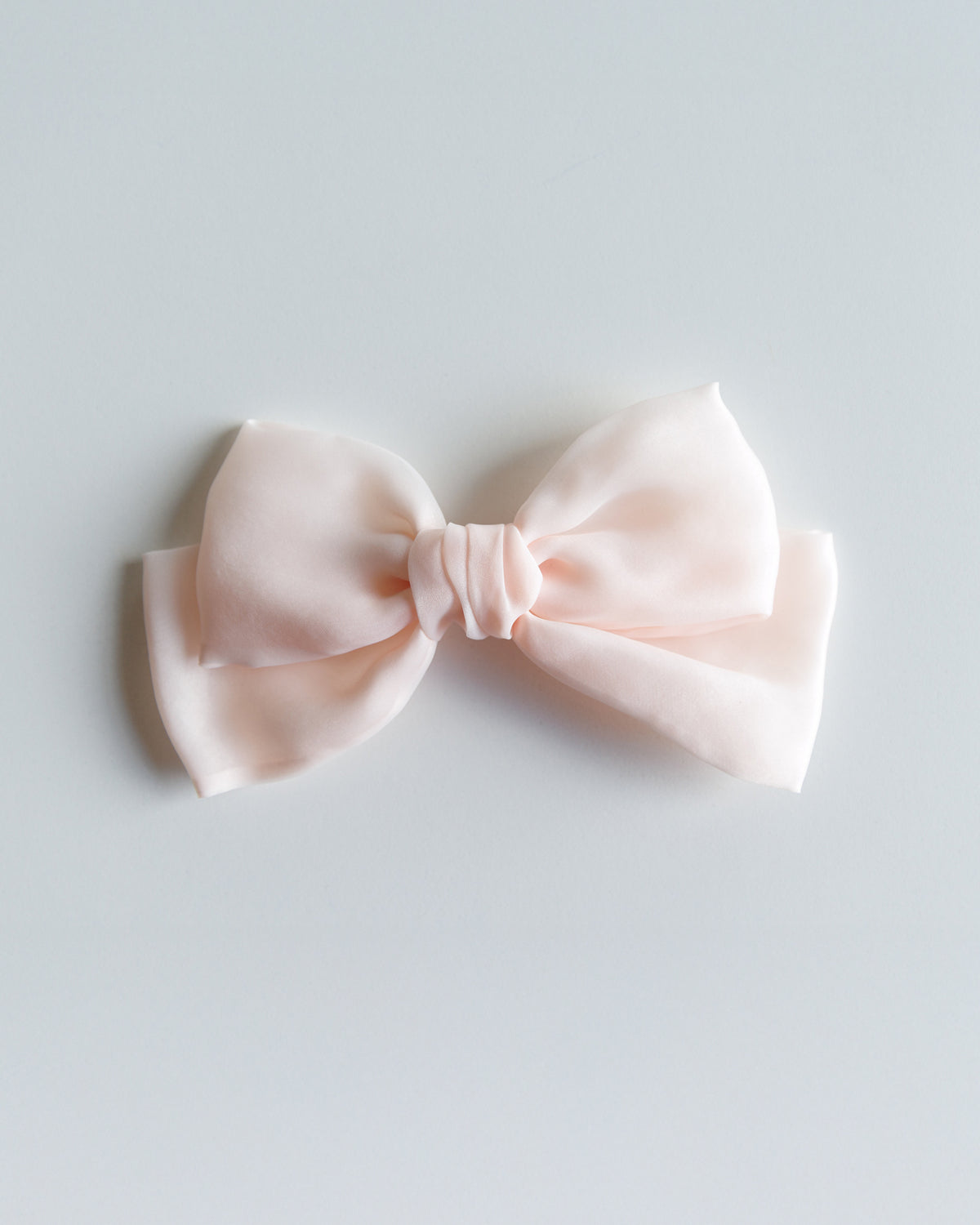 Pink bow on a light gray background