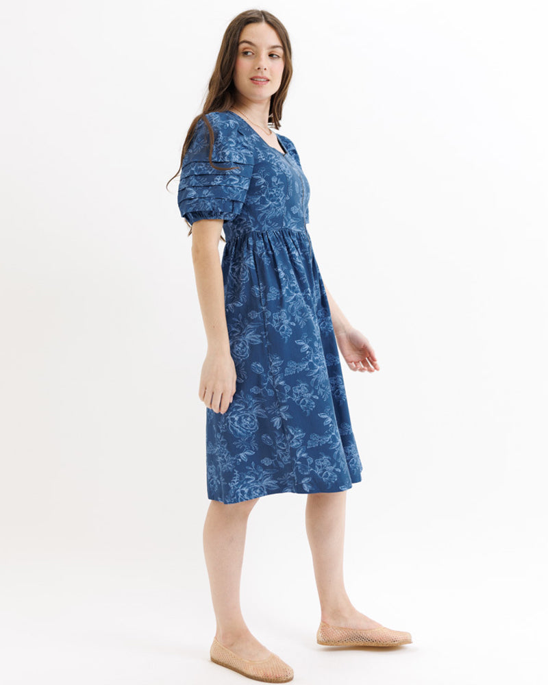 Woman wearing a blue floral dress on a white background