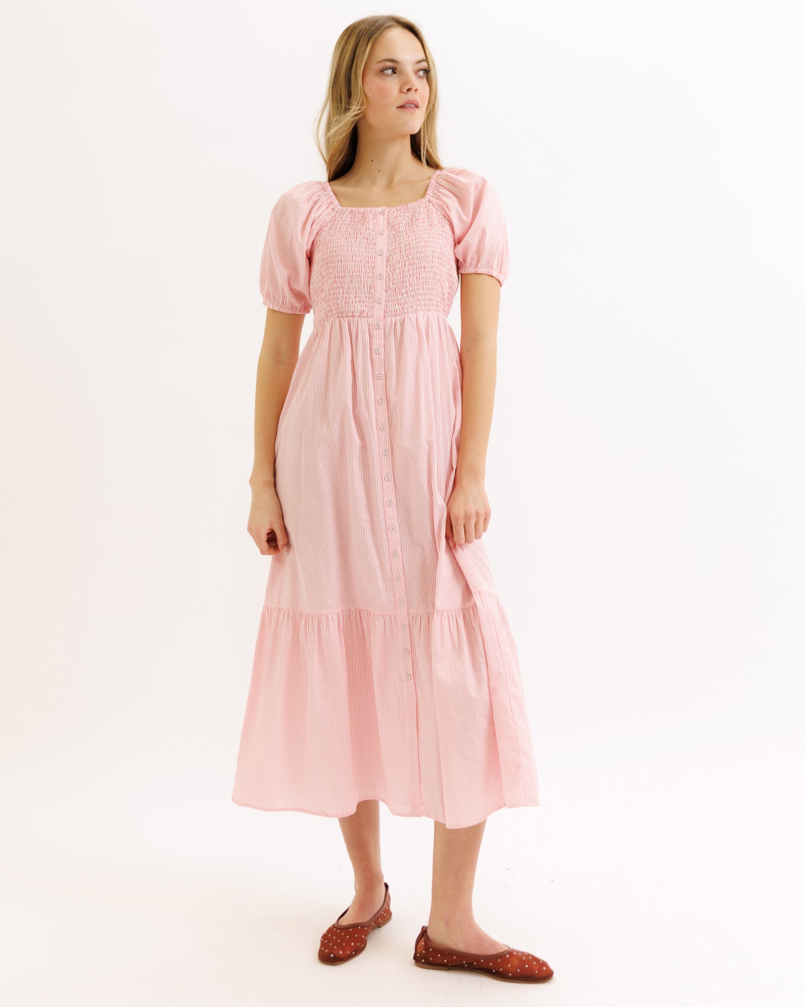Woman wearing a pink dress on a white background
