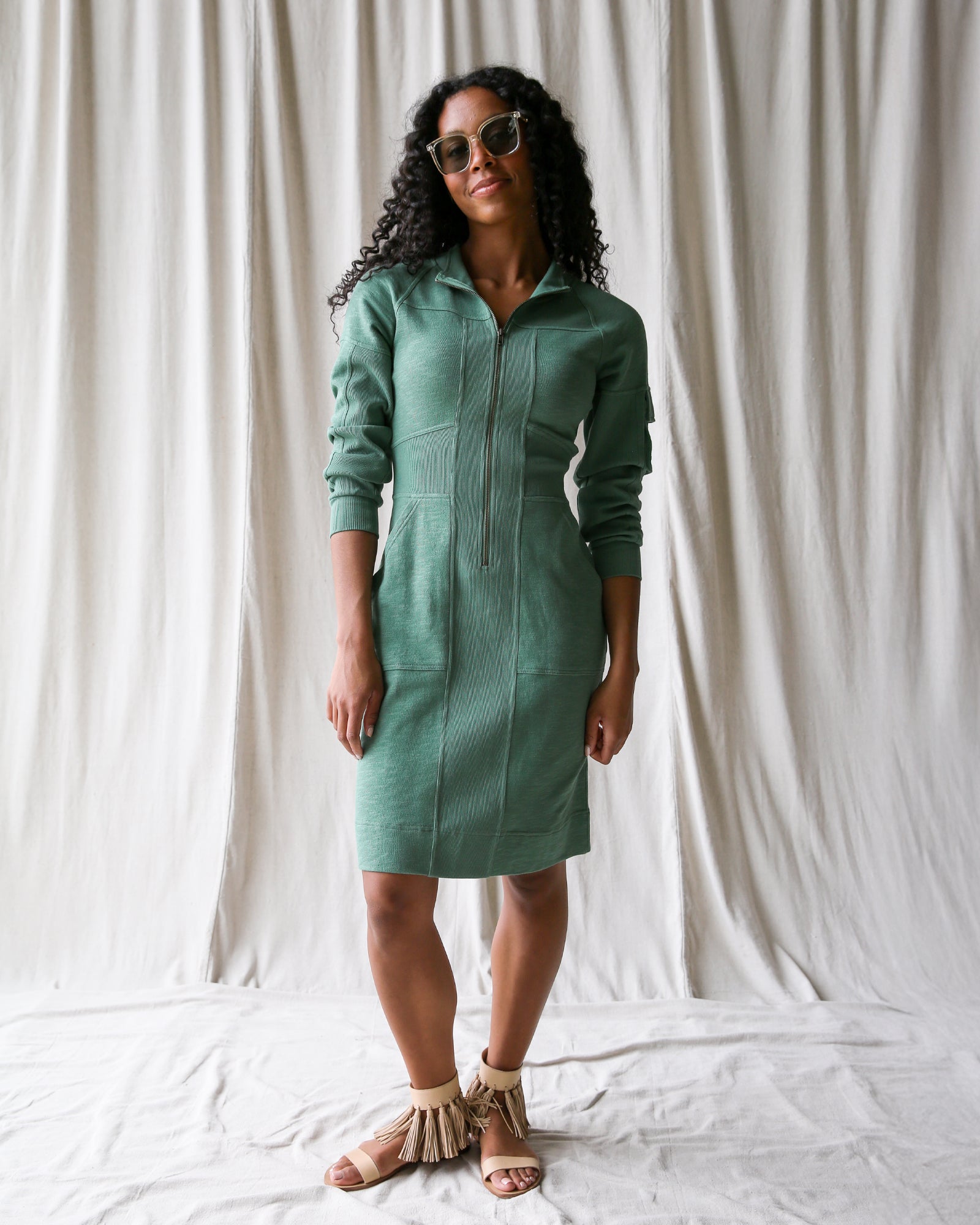 Woman wearing a green dress against a white background