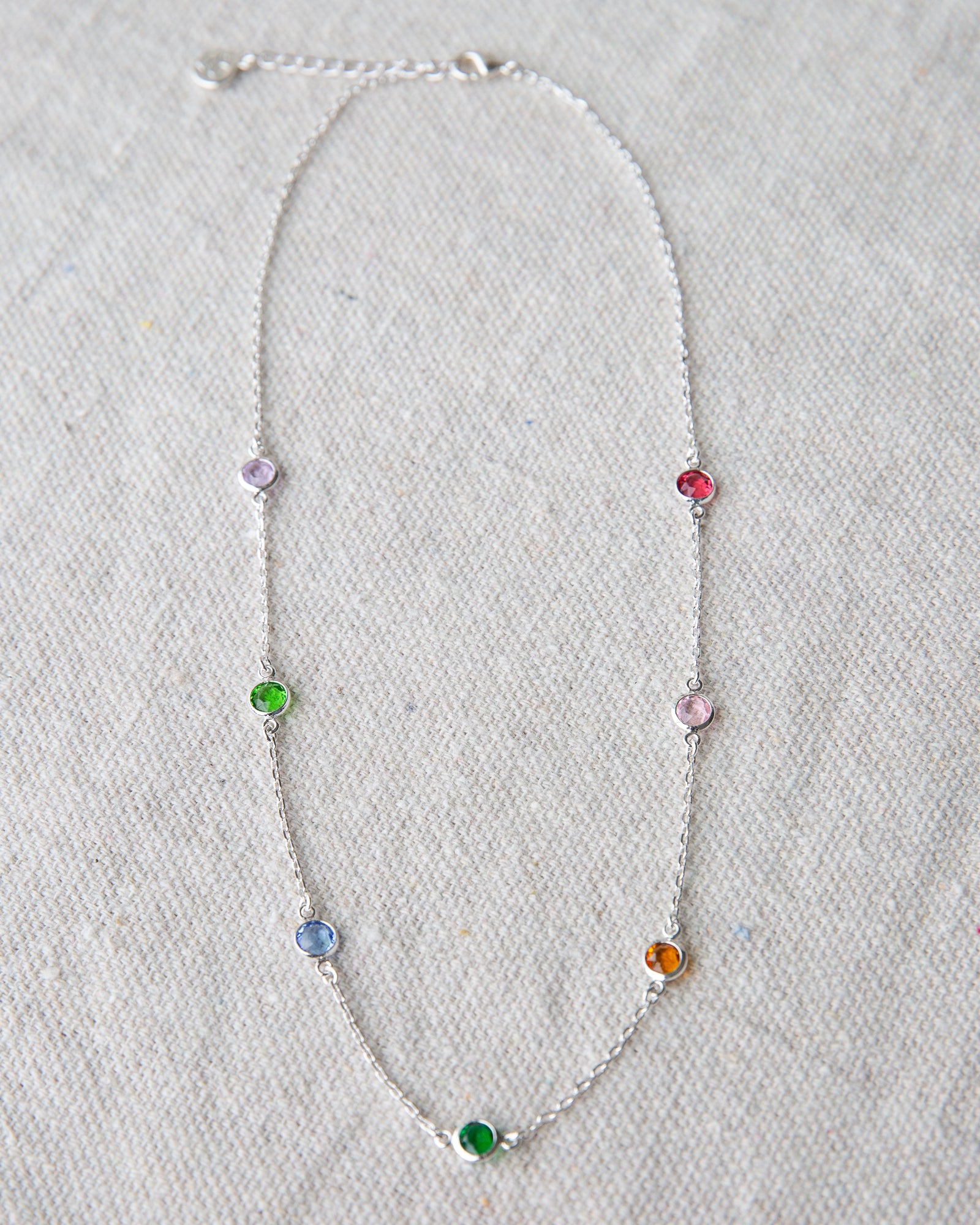 Necklace with colorful beads on a light gray background