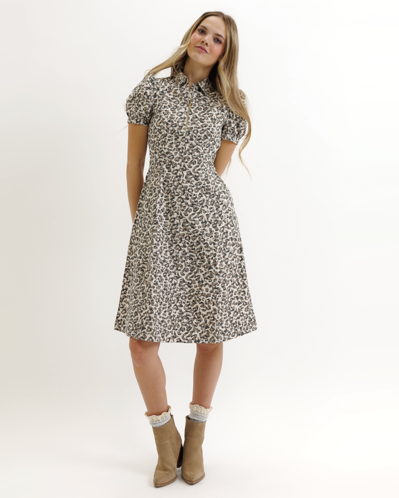 Woman wearing an animal print dress on a white background
