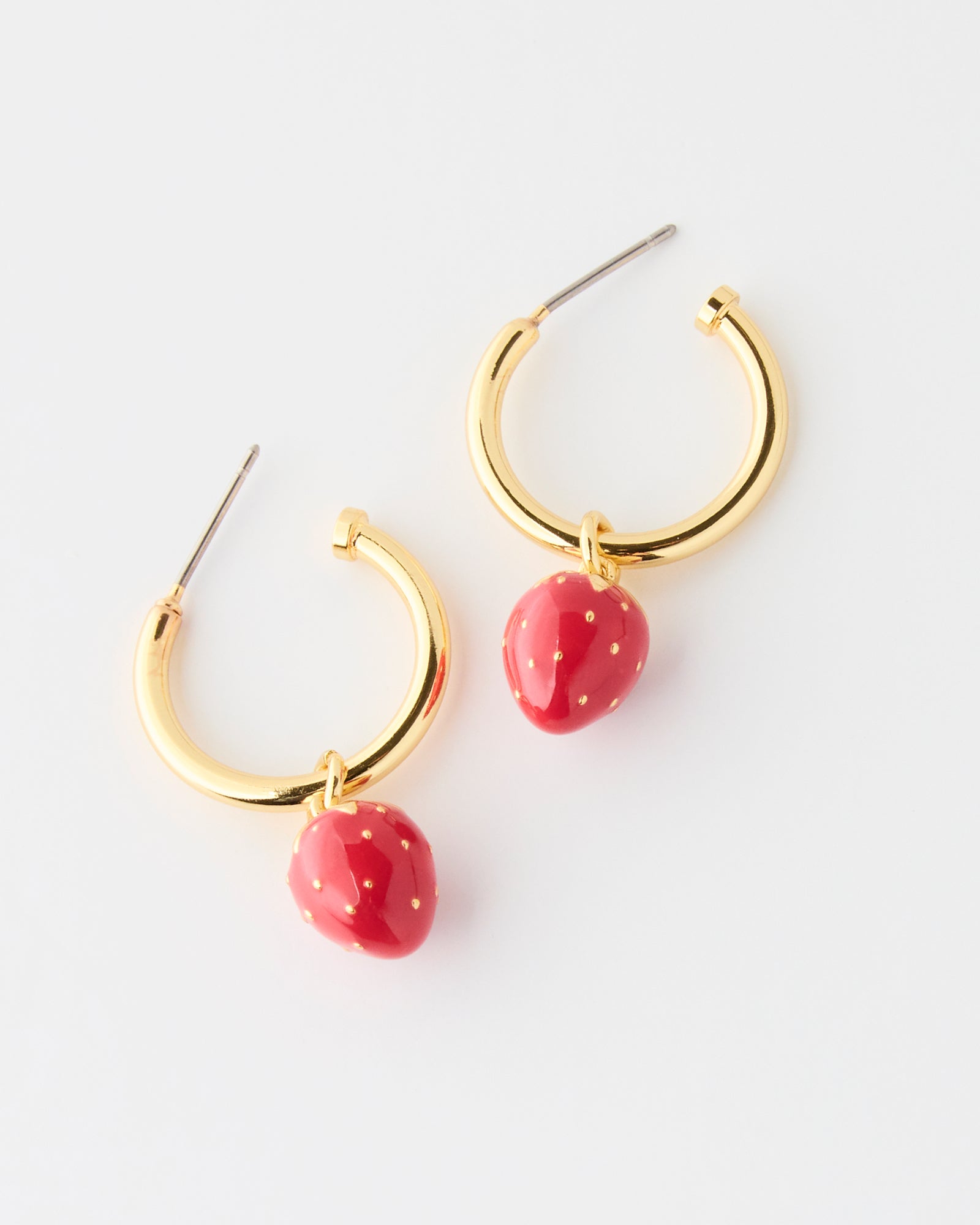 Gold hoop earrings with red strawberry-shaped charms on a white background
