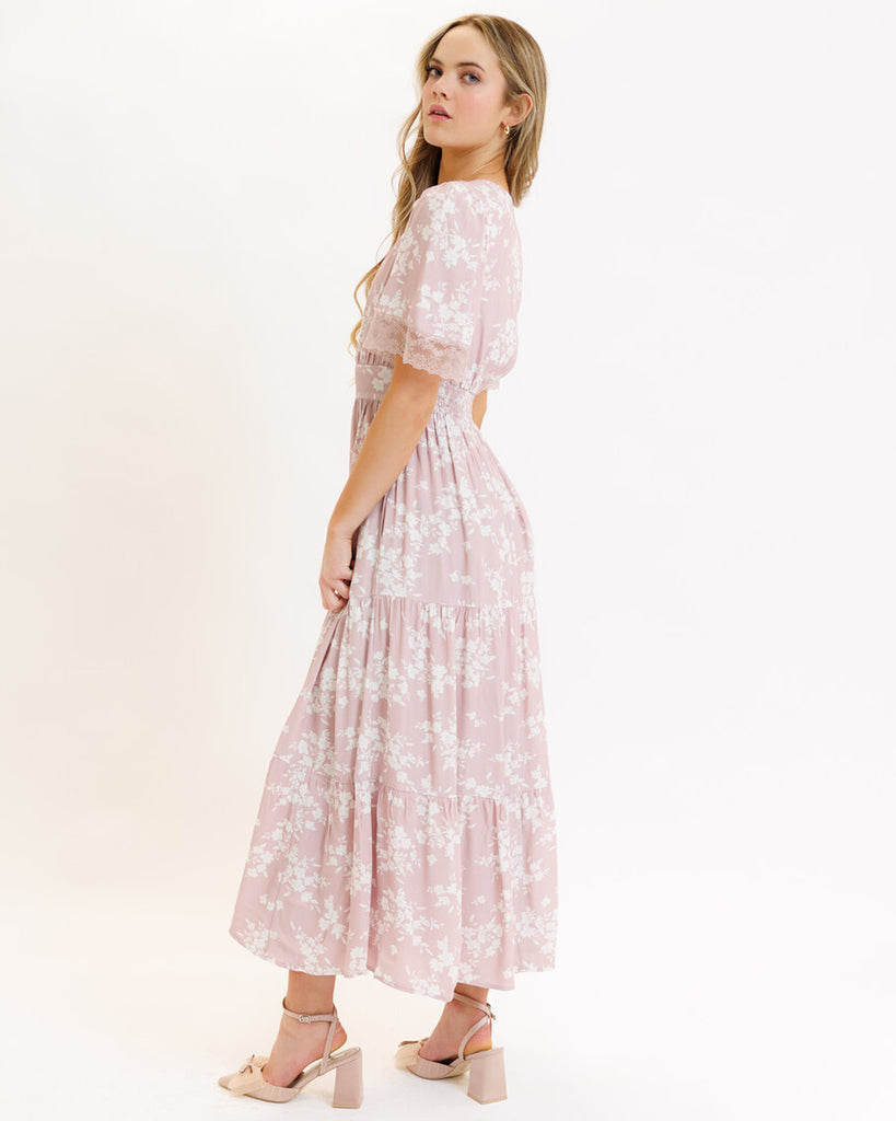 Model wearing a pink floral print short flutter sleeve, v-neck, maxi dress with tiered skirt.