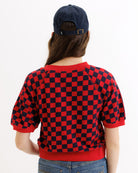 Person wearing a red and black checkered shirt with a white background