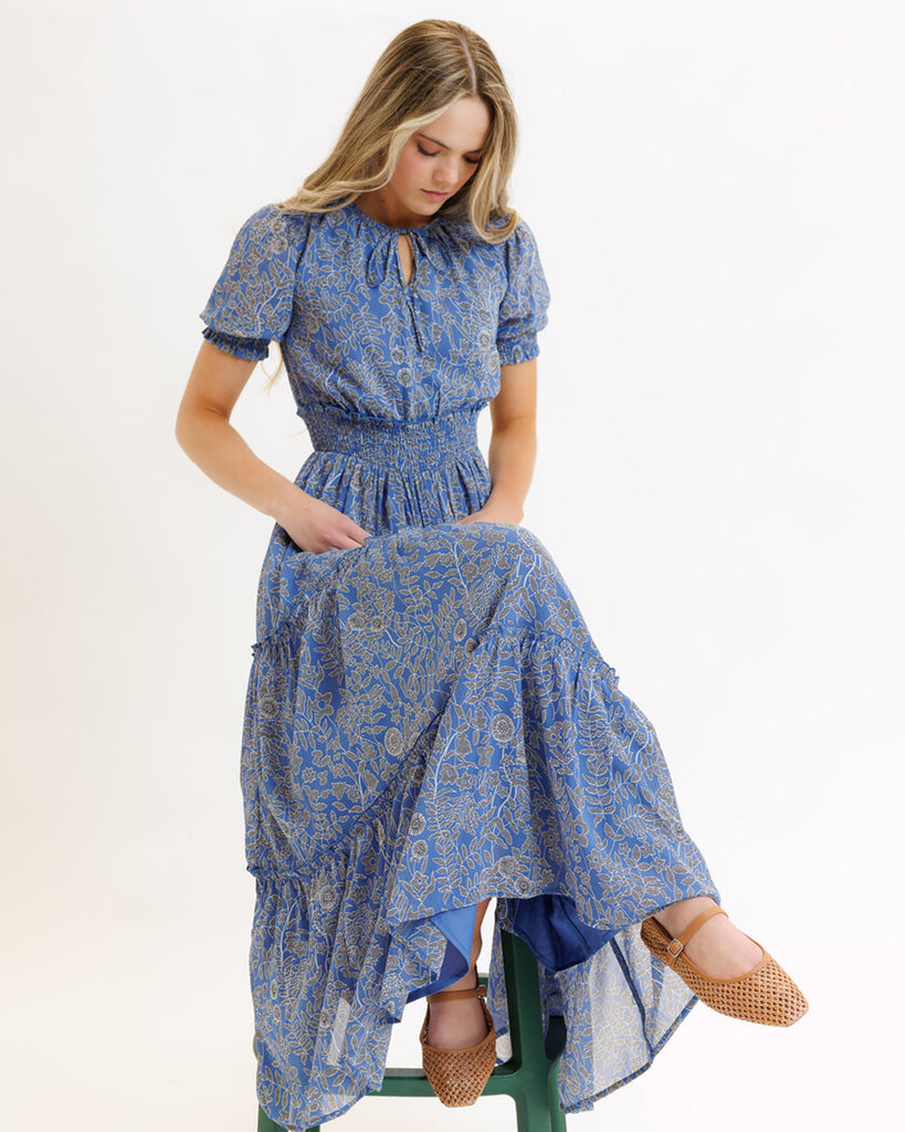 Model wearing a blue mosaic print short sleeve maxi length dress