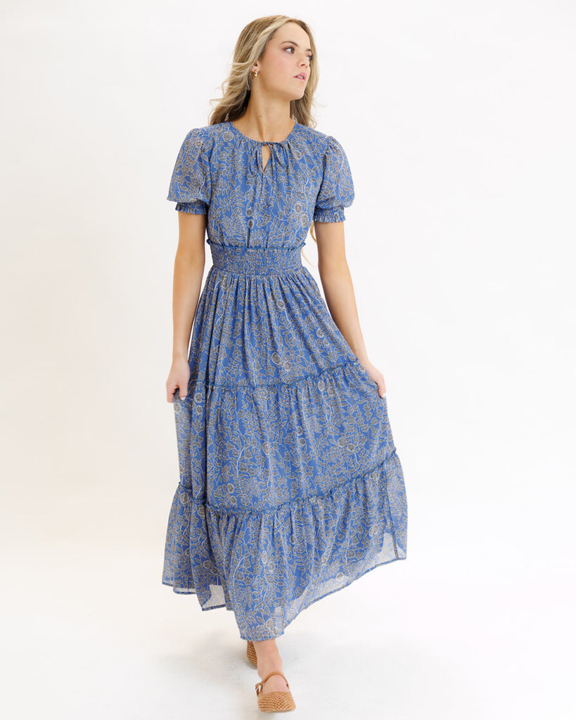 Model wearing a blue mosaic print short sleeve maxi length dress
