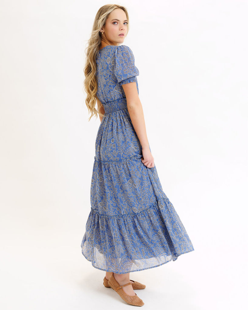 Model wearing a blue mosaic print short sleeve maxi length dress