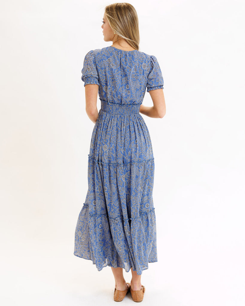 Model wearing a blue mosaic print short sleeve maxi length dress