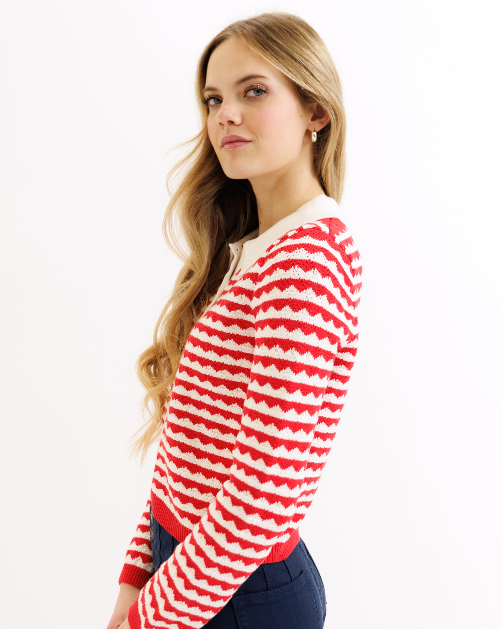 Woman wearing a red and white striped sweater on a white background