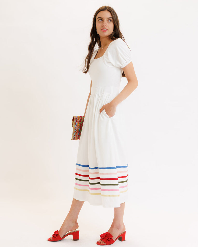 Model wearing a white with rainbow stripes on skirt, short sleeve, square neck, midi dress.