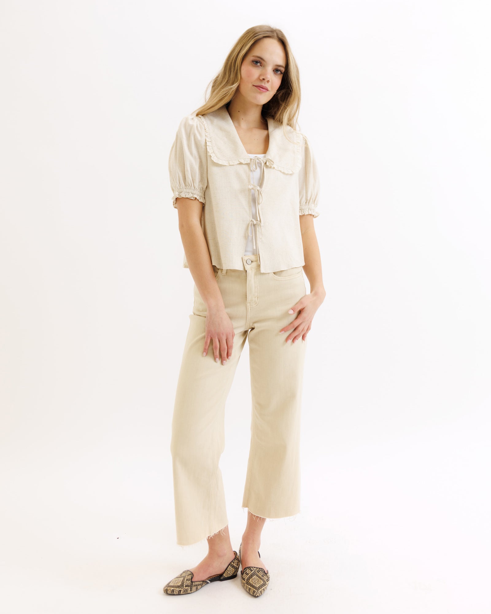 Woman wearing a beige outfit on a white background