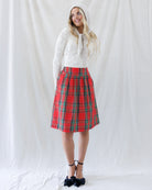 Full-length styled look featuring the fitted ivory textured knit top paired with a red plaid gathered skirt and knit hood scarf.