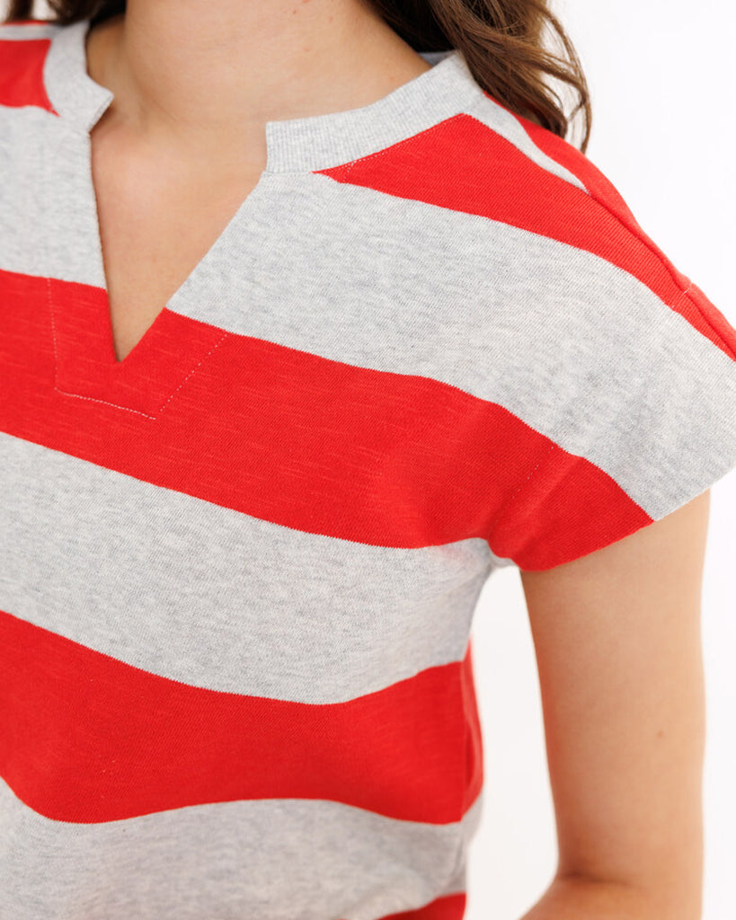 Model wearing a gray and red striped short sleeve v-neck banded tee