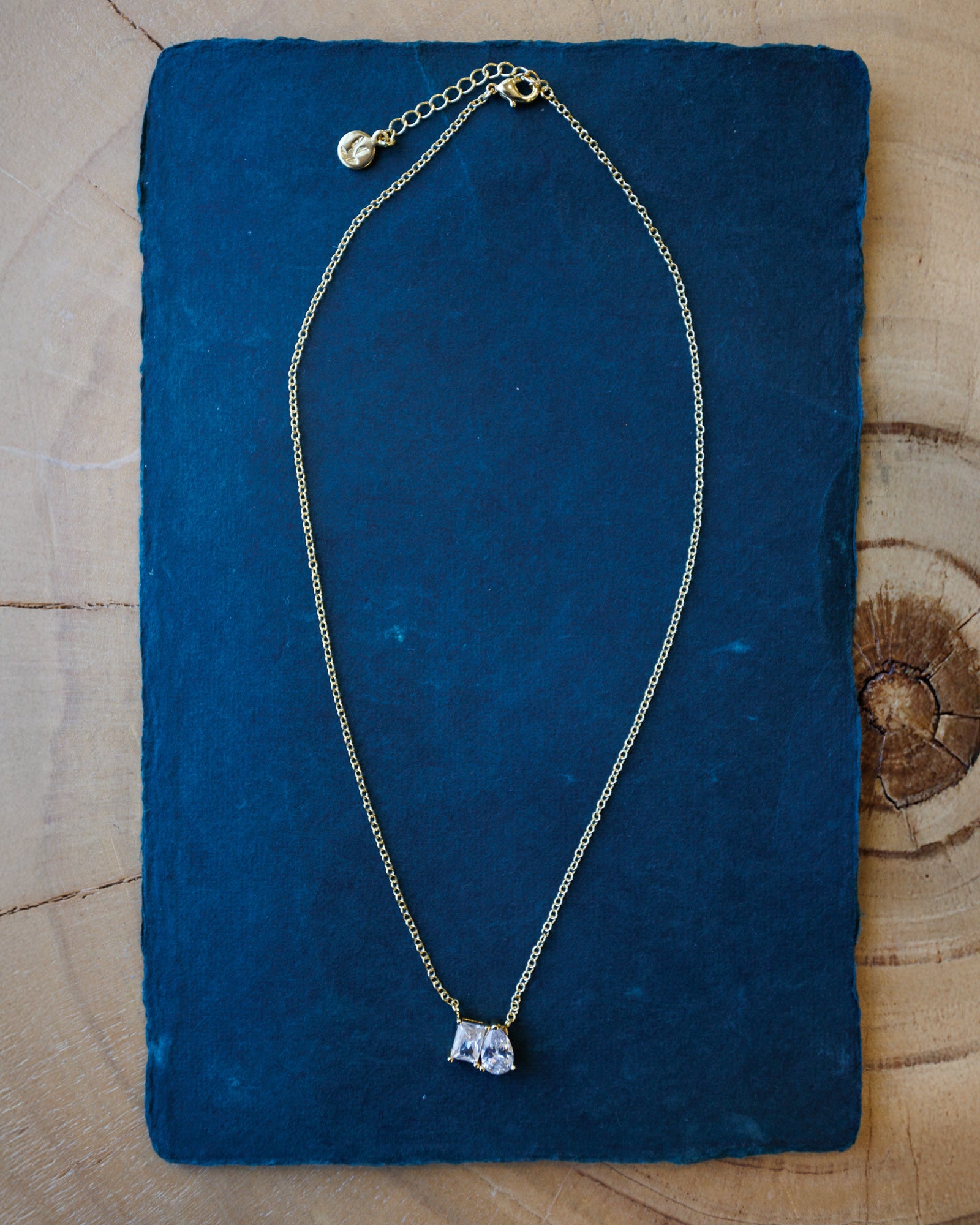 Necklace with a pendant on a blue fabric background