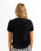 Person wearing a black t-shirt on a white background