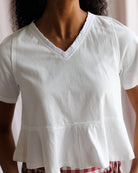 White blouse worn by a person with a blurred background