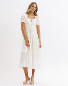 Woman wearing a white dress on a white background
