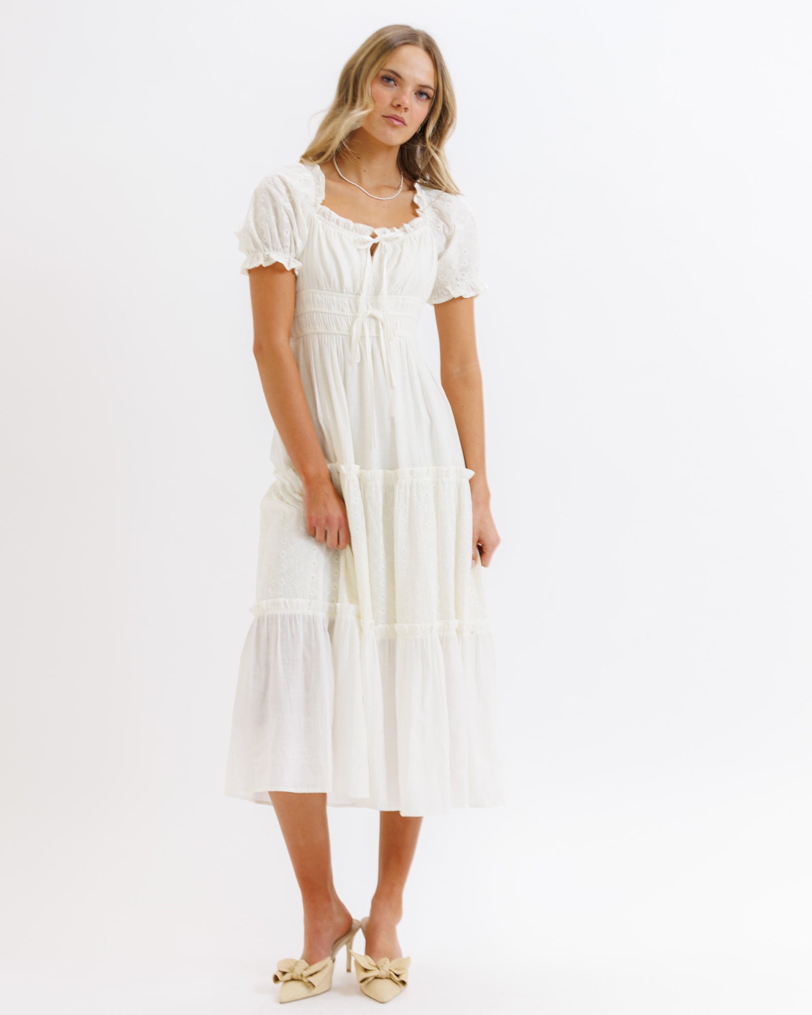 Woman wearing a white dress on a white background