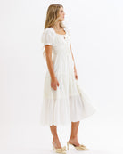 Woman wearing a white dress on a white background