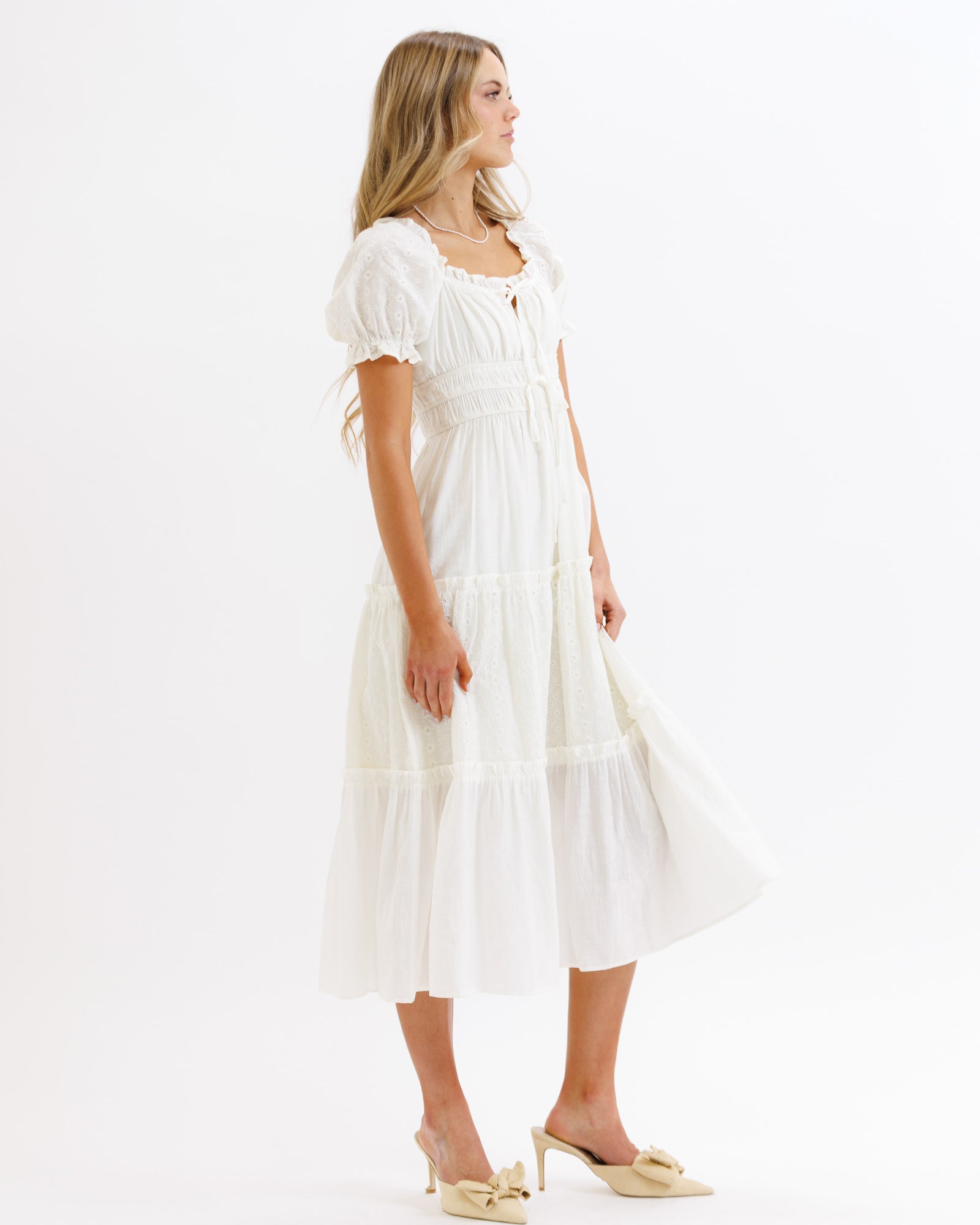 Woman wearing a white dress on a white background