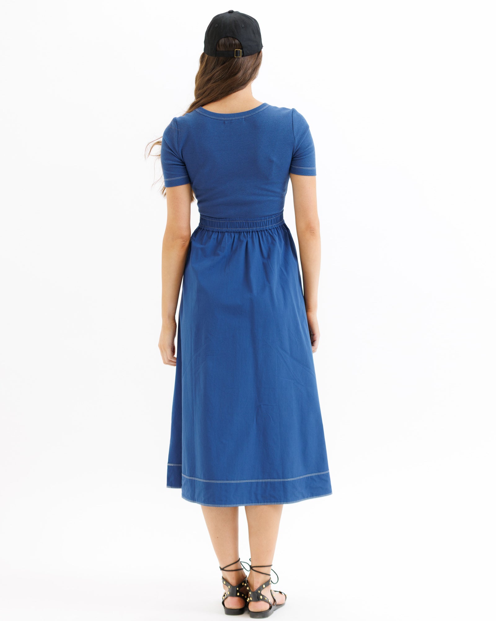 Woman wearing a blue dress on a white background