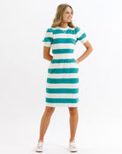 Woman wearing a teal and white striped dress on a white background