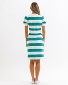 Woman wearing a green and white striped dress on a white background