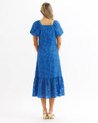 Woman wearing a blue dress on a white background