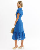 Woman wearing a blue dress with a white background