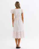 Pink dress with lace details on a white background