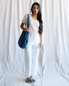 Woman holding a blue bag against a white background