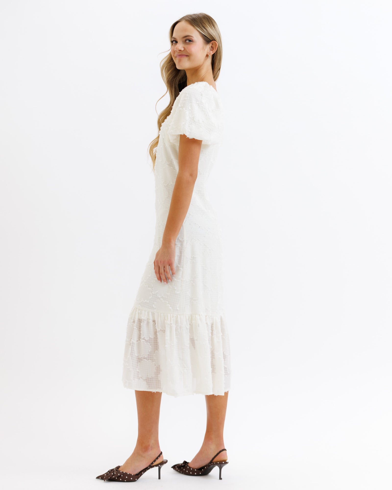 Woman wearing a white dress on a white background