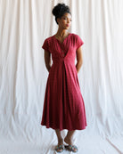 Woman wearing a red dress against a white background